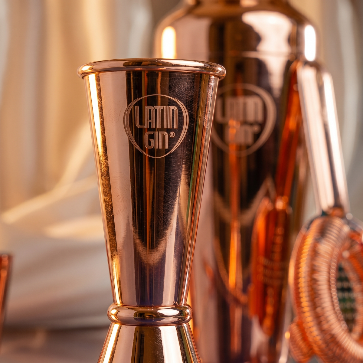 Latin Gin double-ended jigger in a rose gold finish with engraved logo